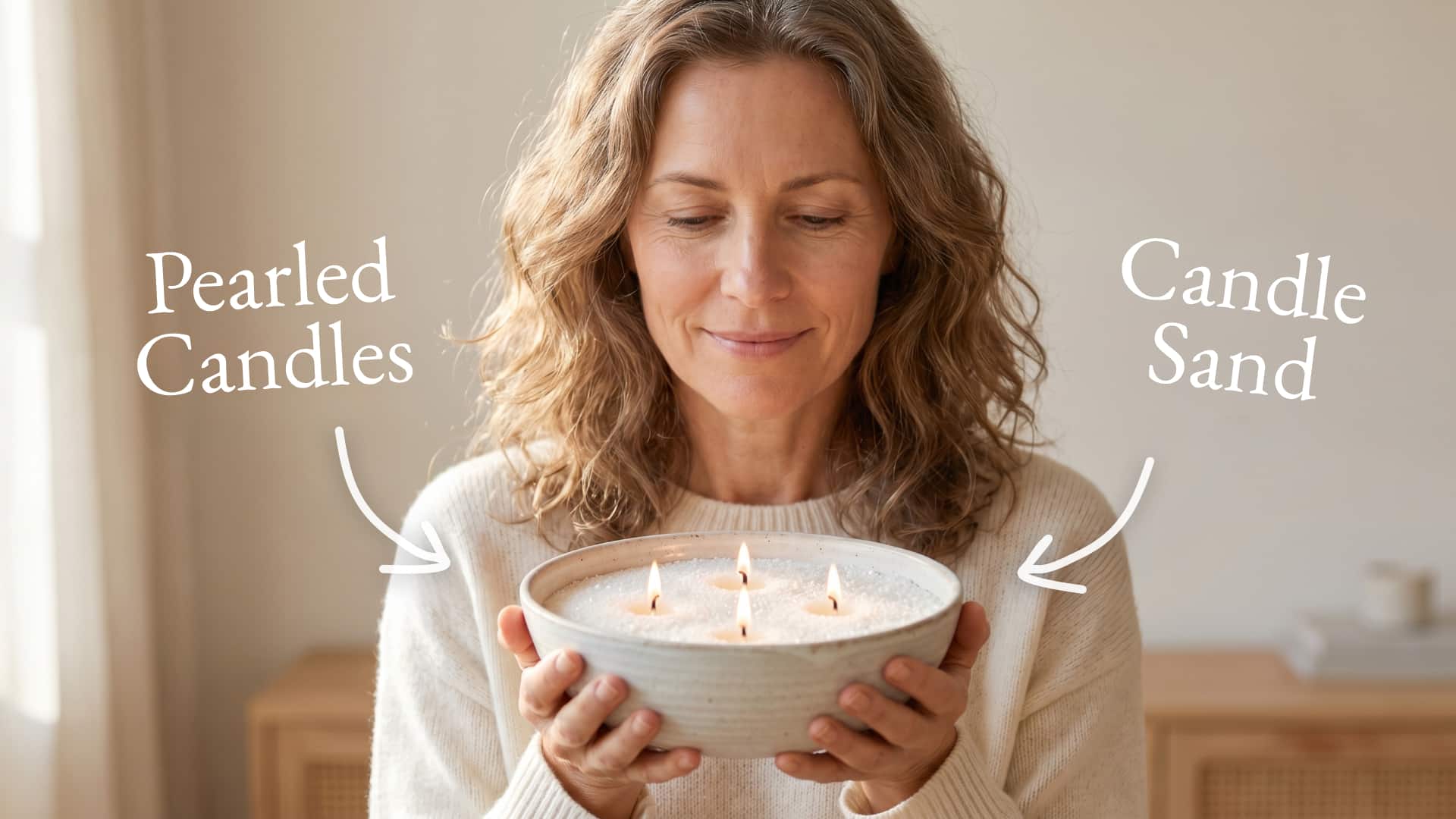 Woman holding bowl of candle sand with five lit wicks, labeled "Pearled Candles" and "Candle Sand"